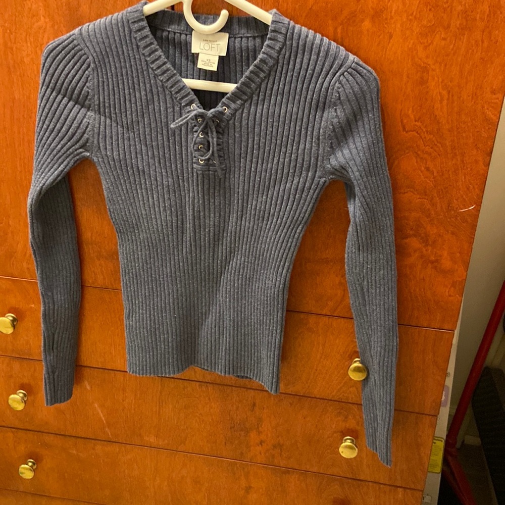 Blue sweater. V-neck with ties